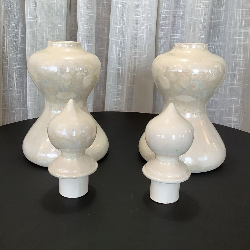 Two ceramic canisters with lids detached against neutral background 