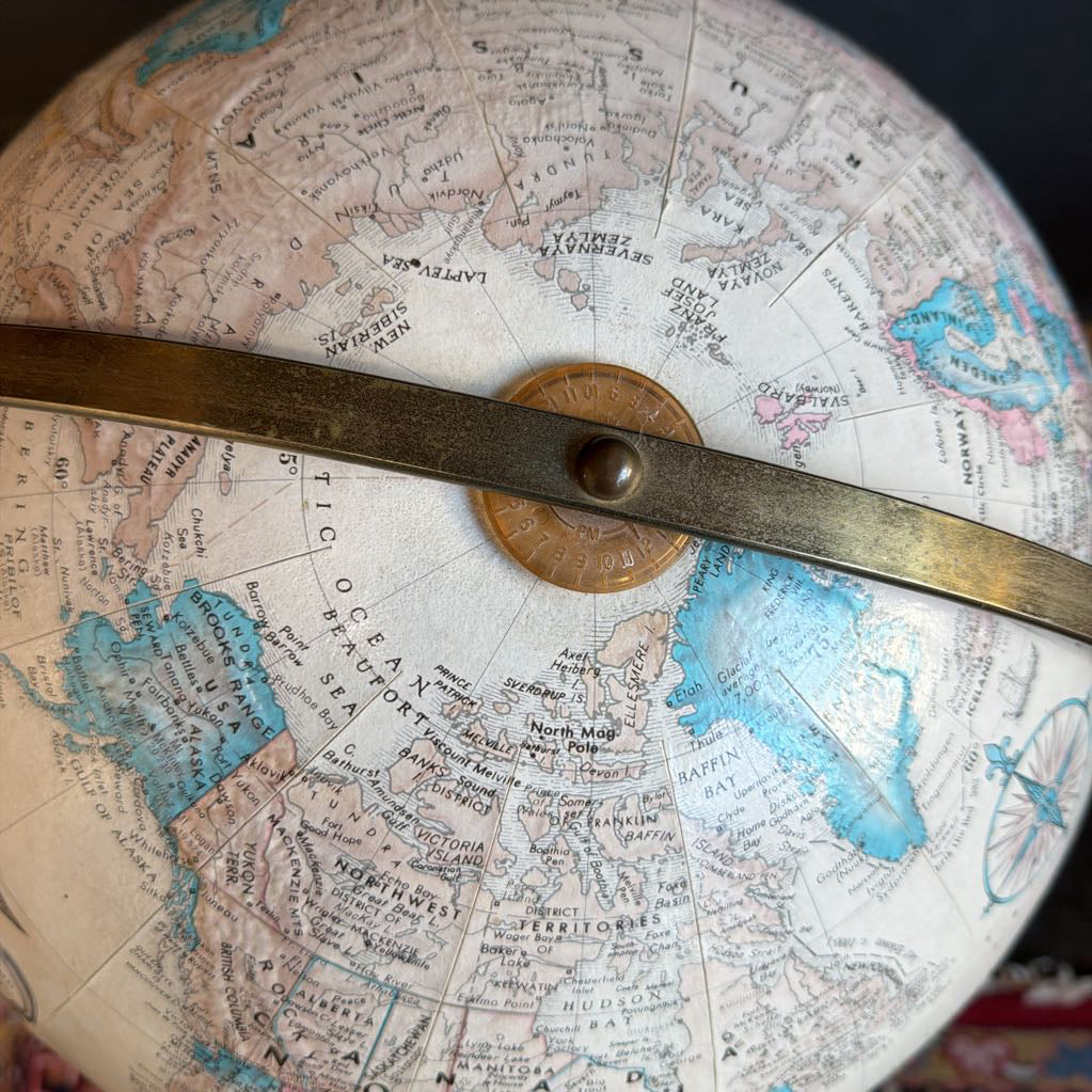 Close-up of a vintage globe with a brass compass rose.