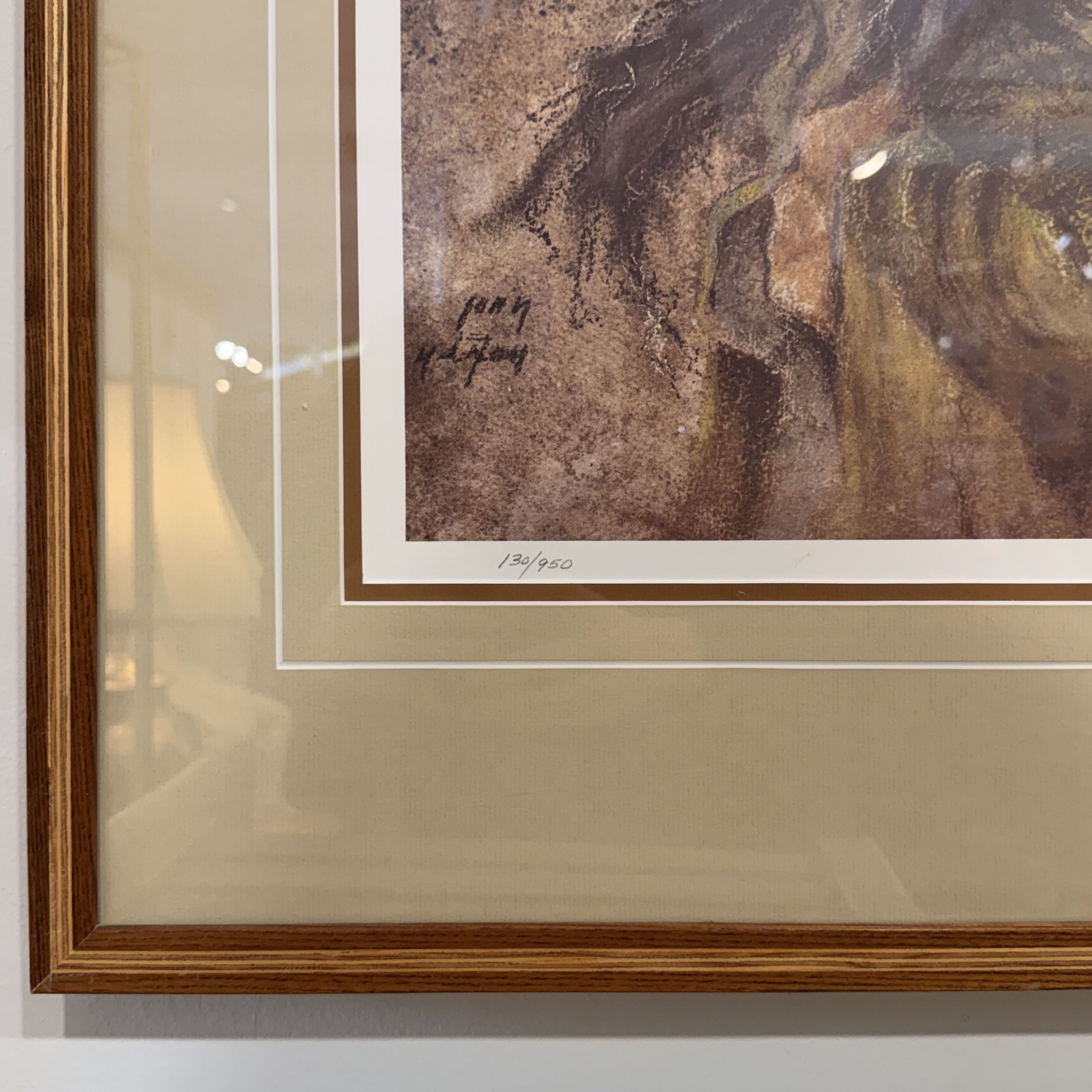 Framed artwork with a signature on a neutral background