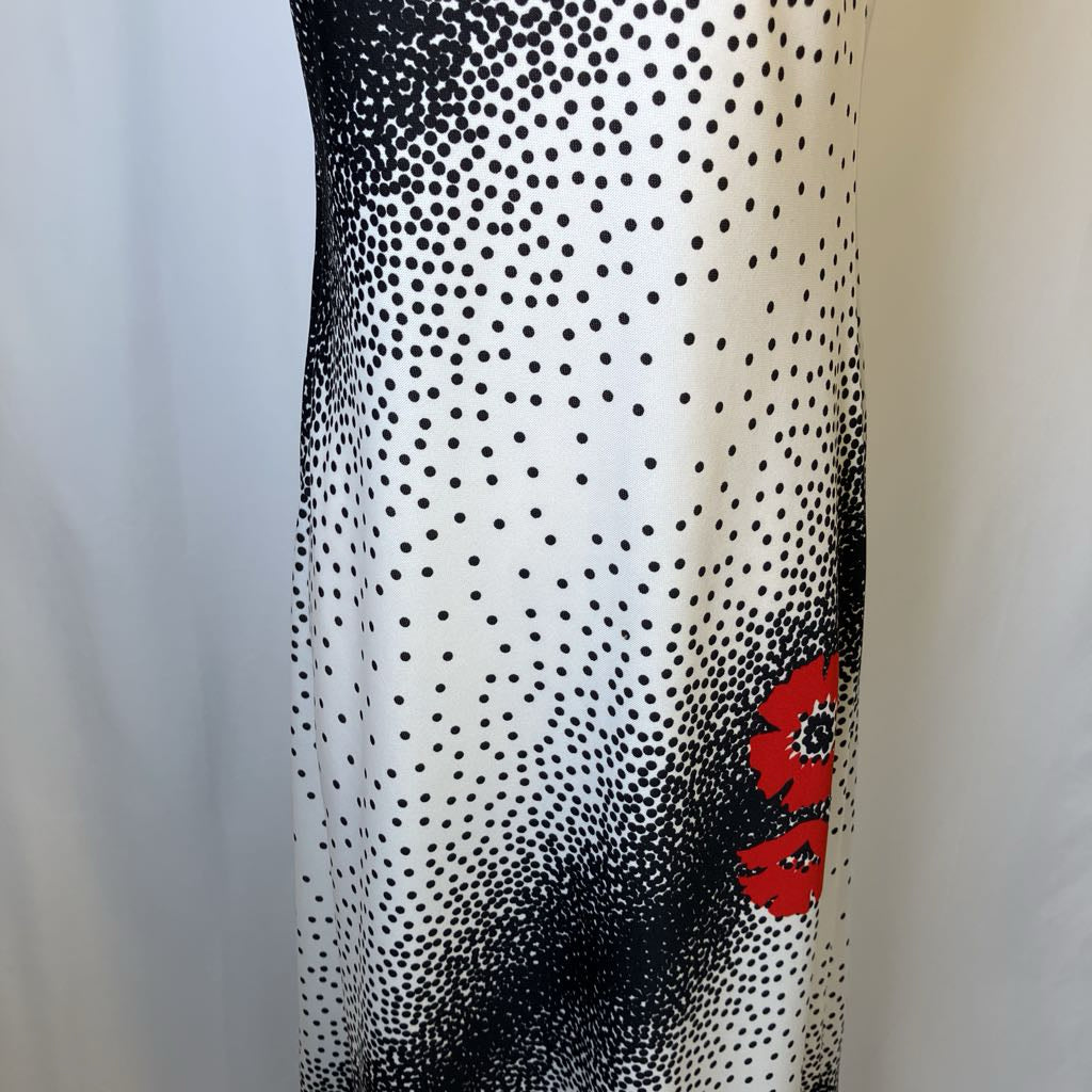 Black and white polka dot pattern with a red logo on a sheer fabric background