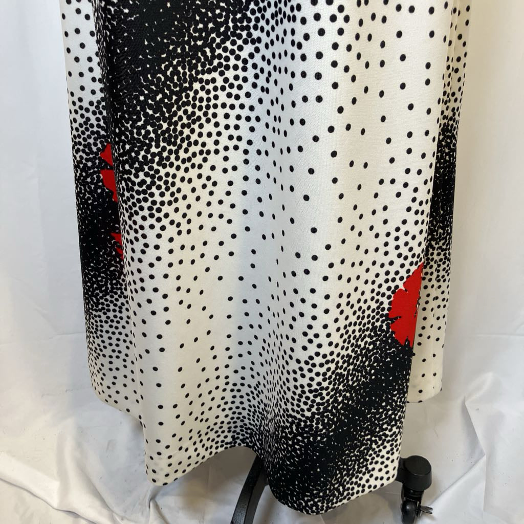 Black and white polka dot pattern with red accents on a white background