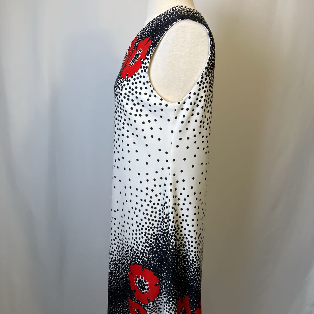 Mannequin wearing a sleeveless top with black and white polka dot pattern and red floral designs.