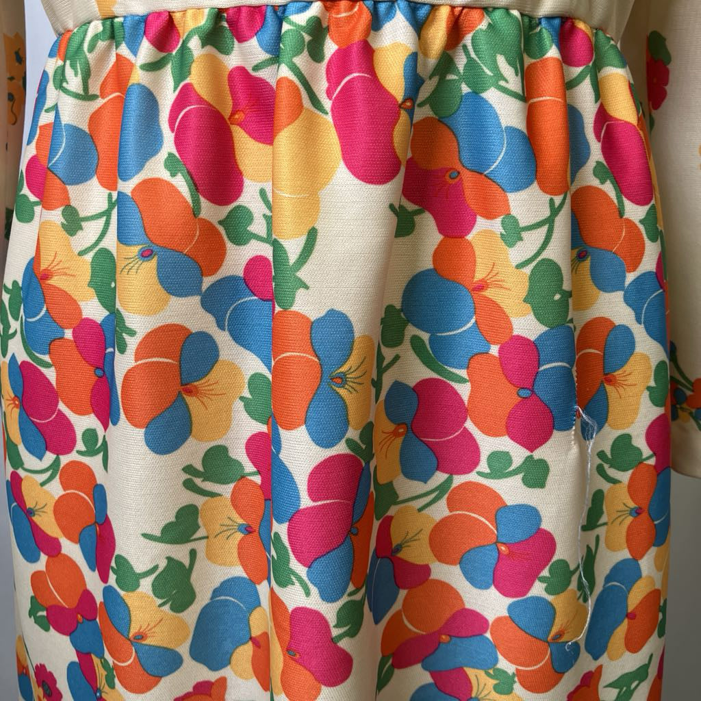 Colorful floral-patterned fabric with butterflies on a white background