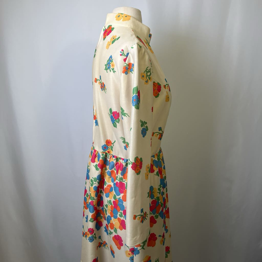 Colorful floral dress on a mannequin against a plain background