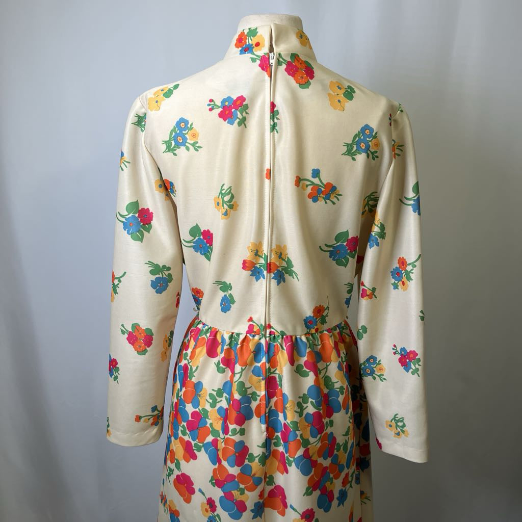 Colorful floral-patterned dress on a mannequin against a plain background