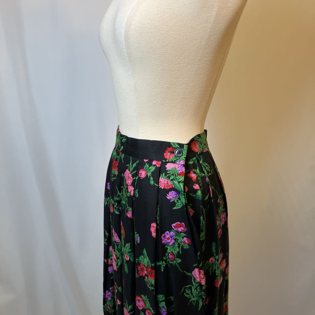 Floral skirt on a mannequin against a plain background