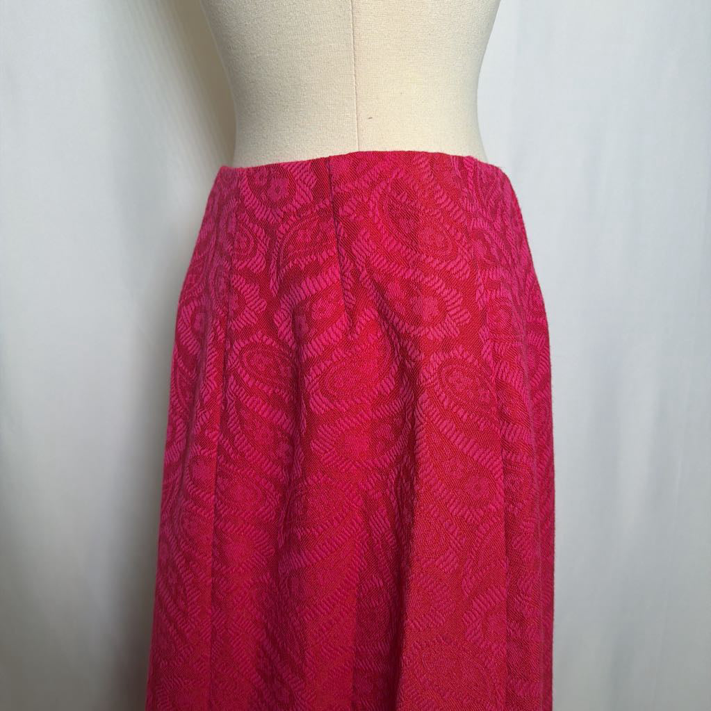 Red patterned skirt on a mannequin against a white background