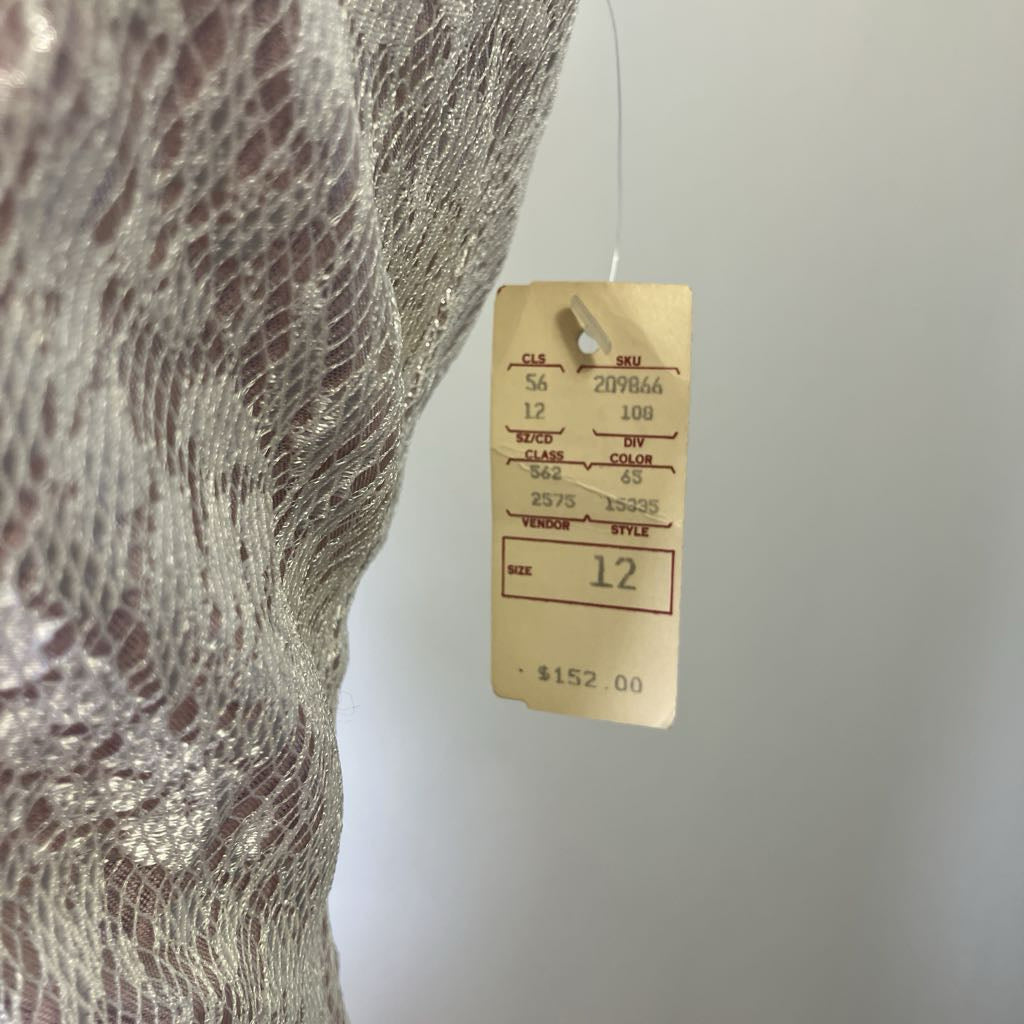 Close-up of a textured fabric with a price tag on a plain background