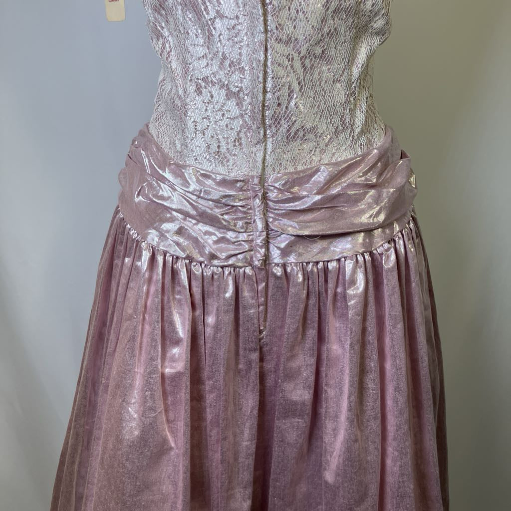 Mannequin wearing a pink and silver dress with a plain background