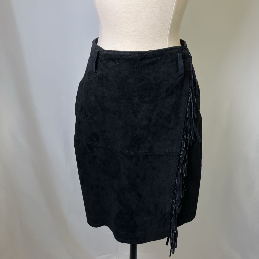 Black suede skirt with fringe on a mannequin against a plain background