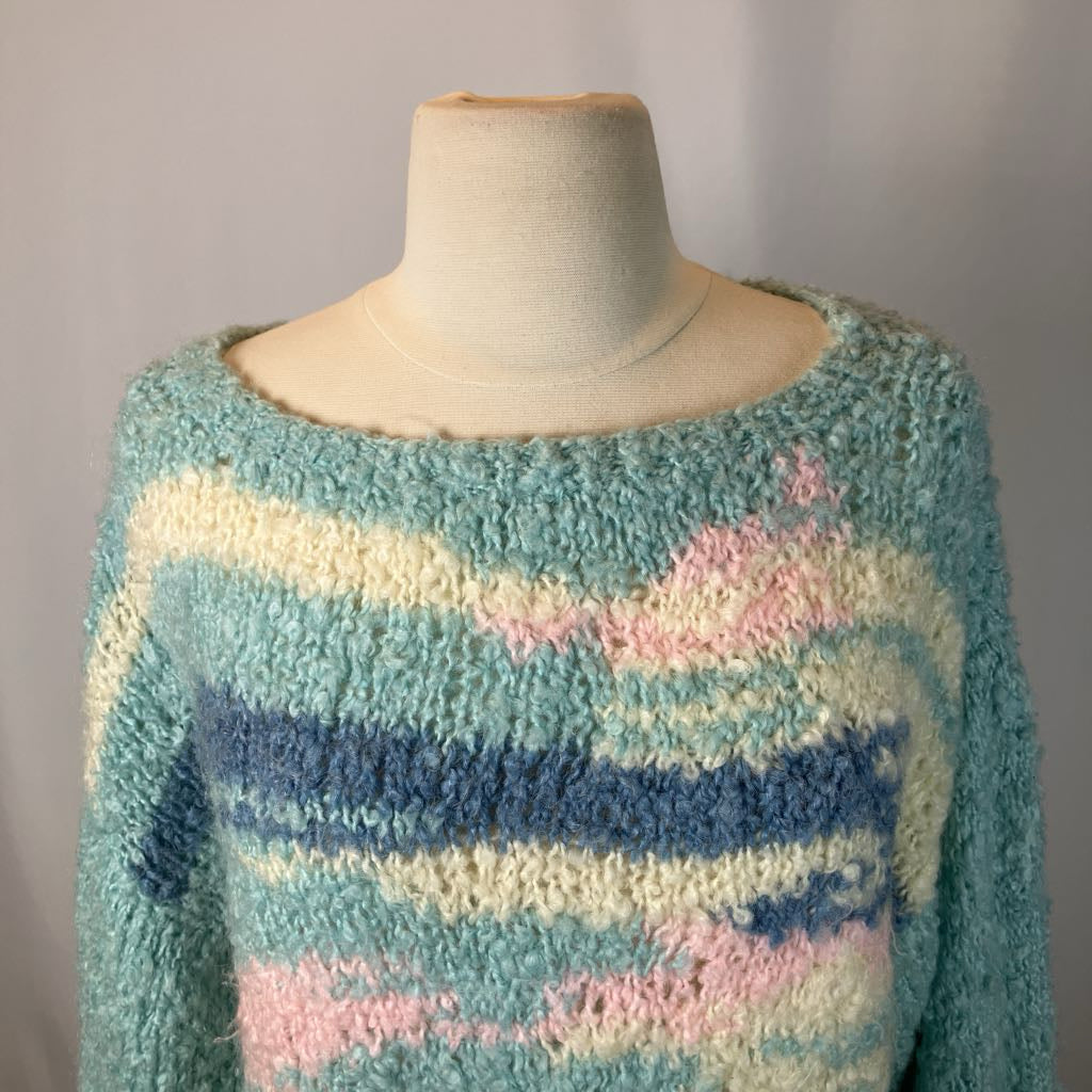 Pastel striped sweater on a mannequin against a plain background