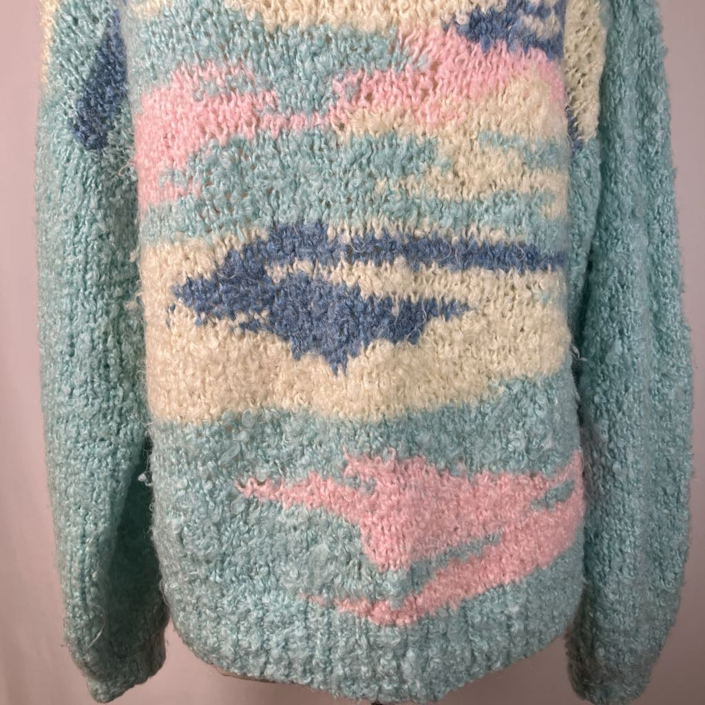 Pastel-colored sweater with abstract patterns on a plain background