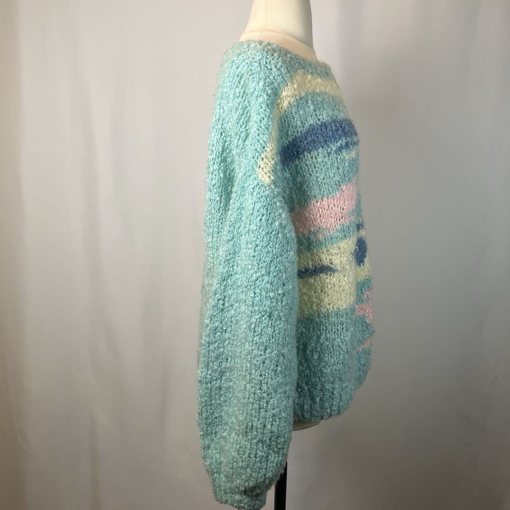 Pastel-colored knitted sweater on a mannequin against a plain background