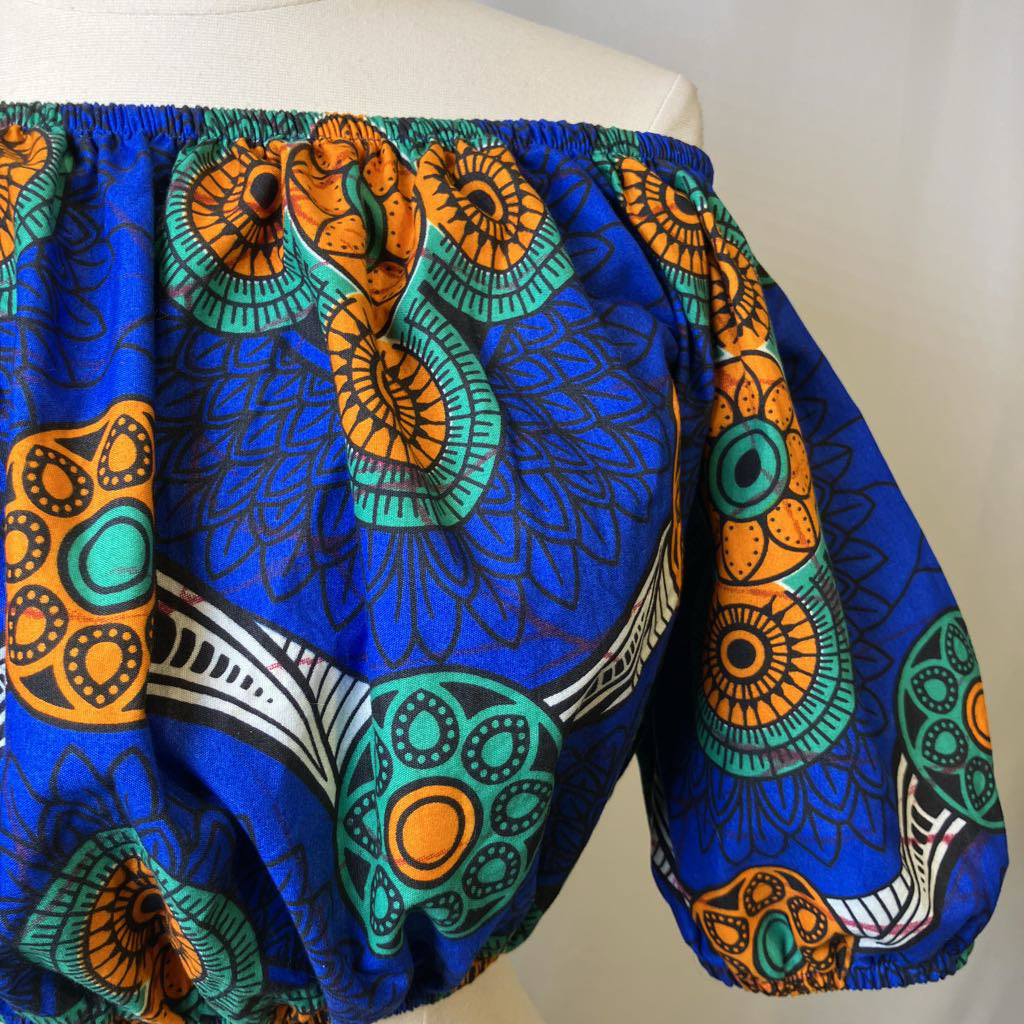 Colorful patterned skirt on a mannequin against a white background