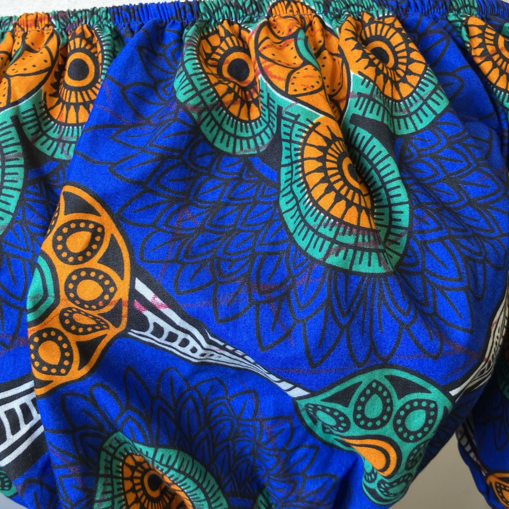 Close-up of colorful fabric with blue, orange, and green patterns