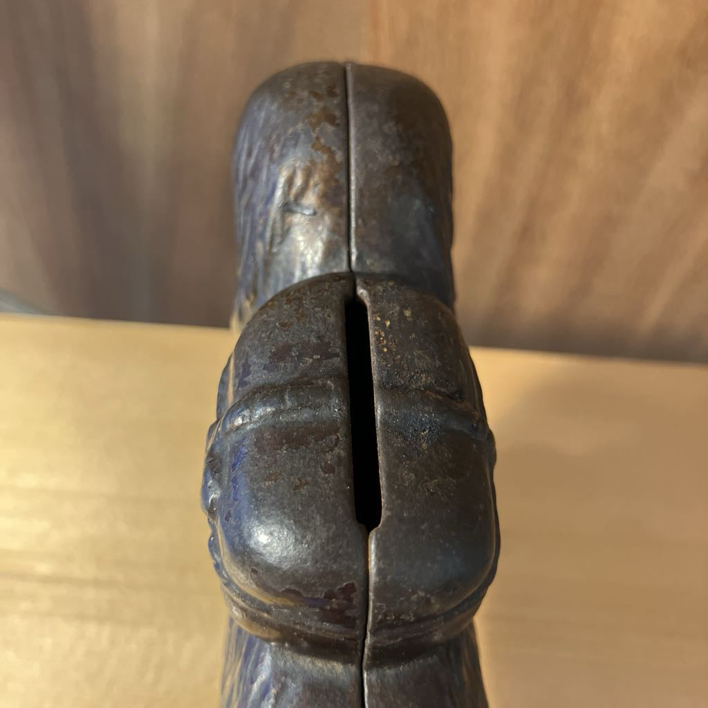 Close-up of a metallic object with a textured surface on a wooden background