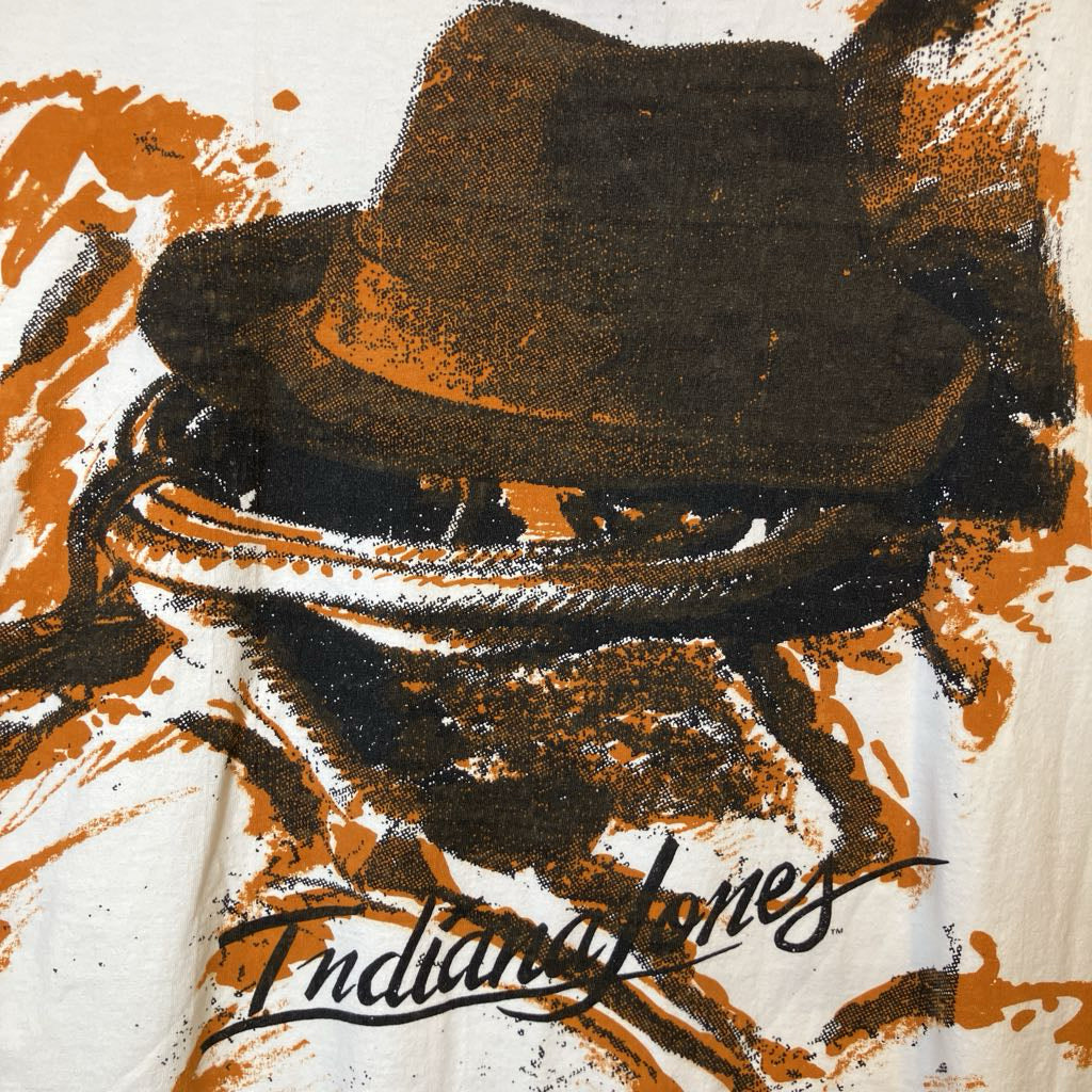 Illustration of a fedora hat with 'Indiana Jones' branding on a textured background