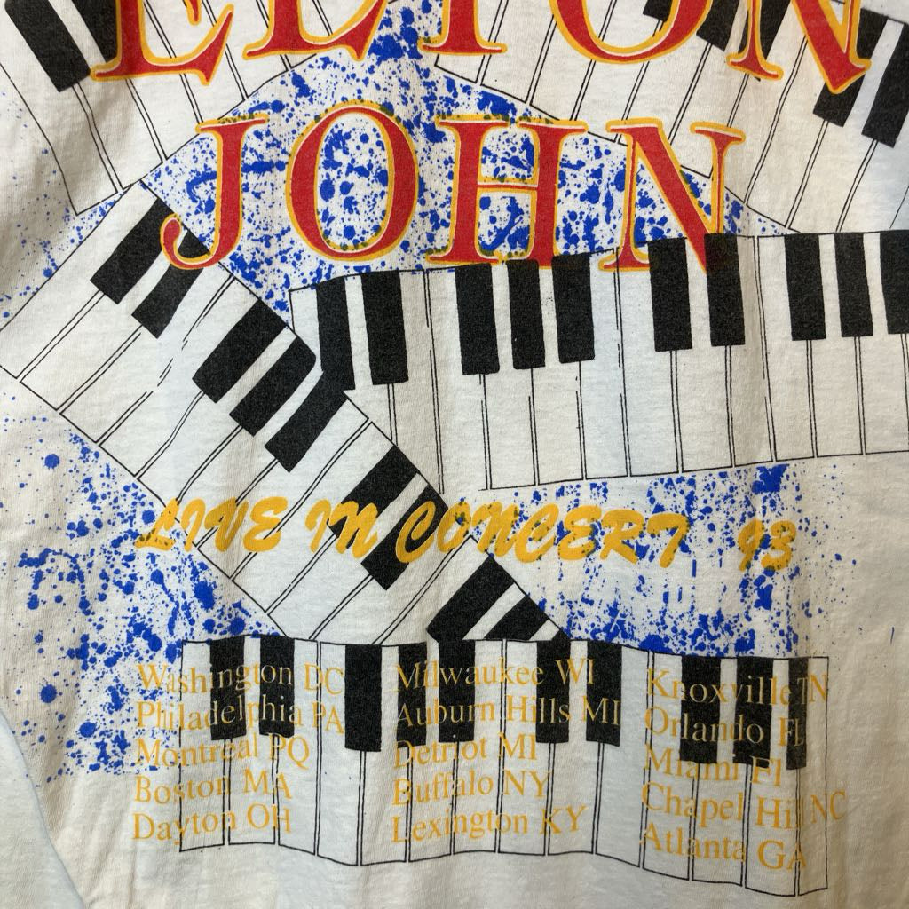 Album cover with keyboard design and text about a concert tour by a well-known artist.