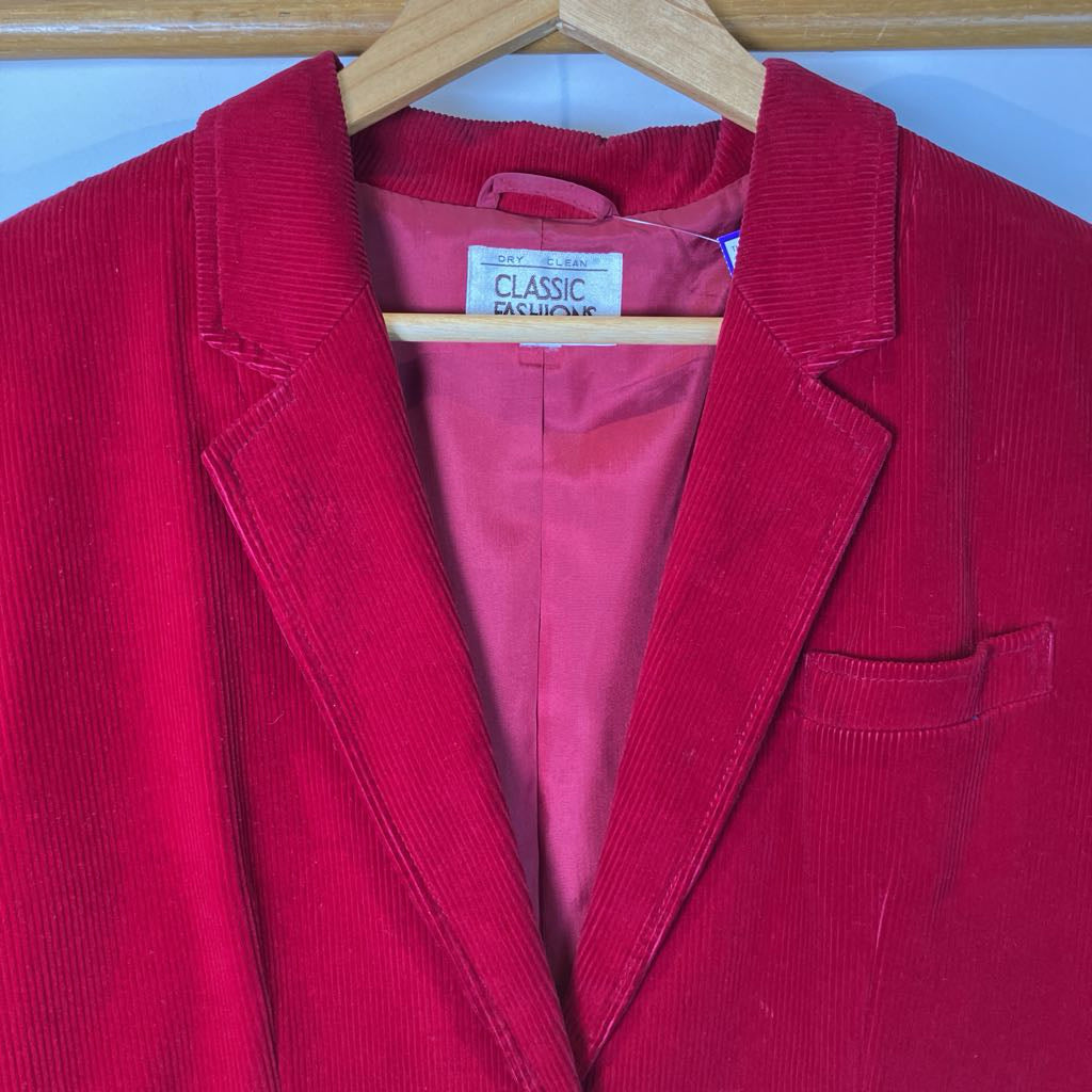 Red corduroy blazer on a hanger with 'Classic Fashions' label.