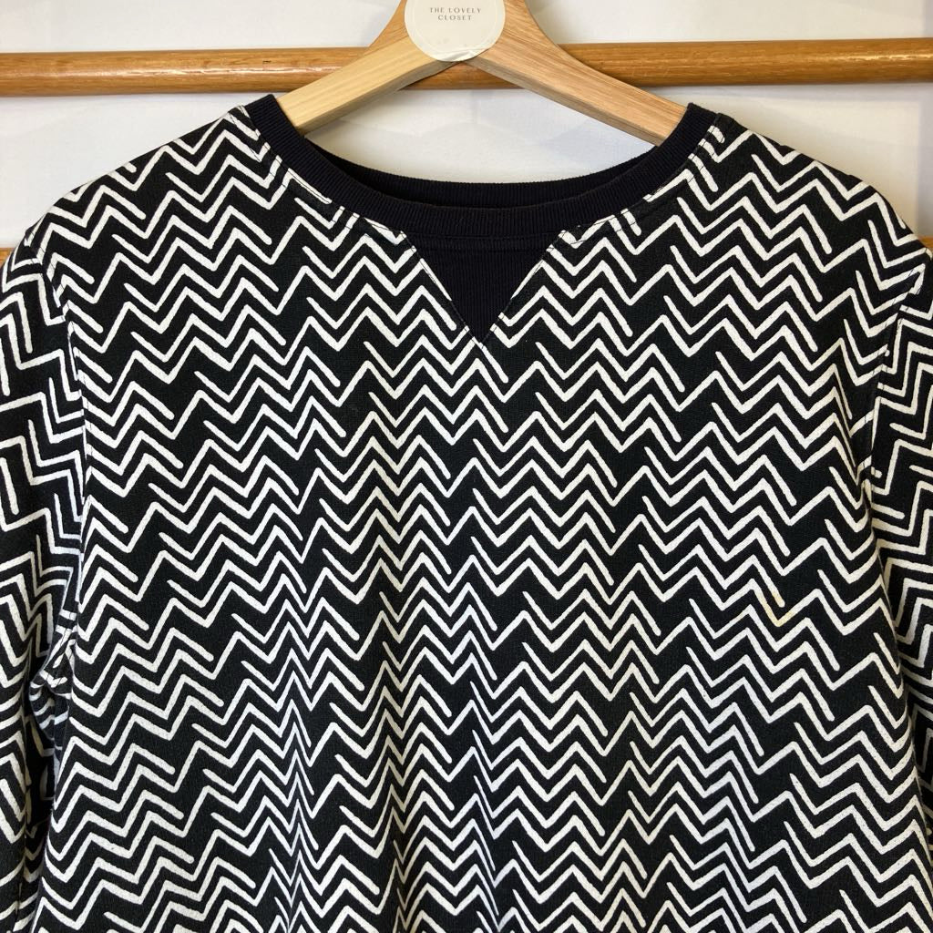 Black and white zigzag patterned shirt on a hanger