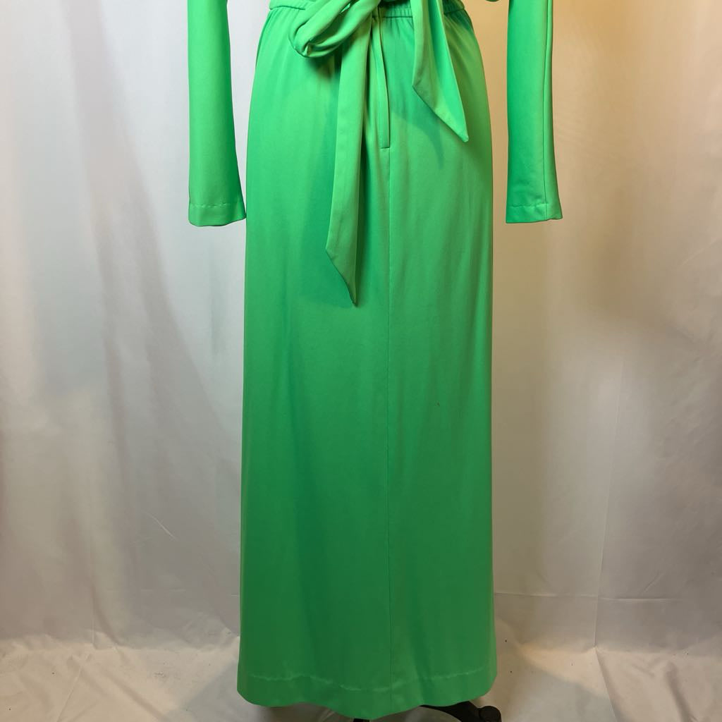 Green dress with long sleeves and a belt on a white background