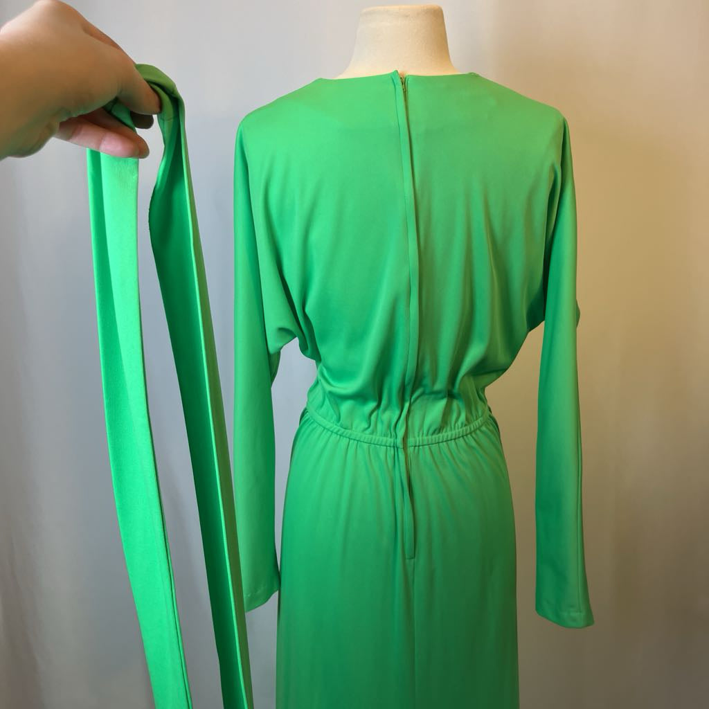 Green dress on a mannequin with a blurred background