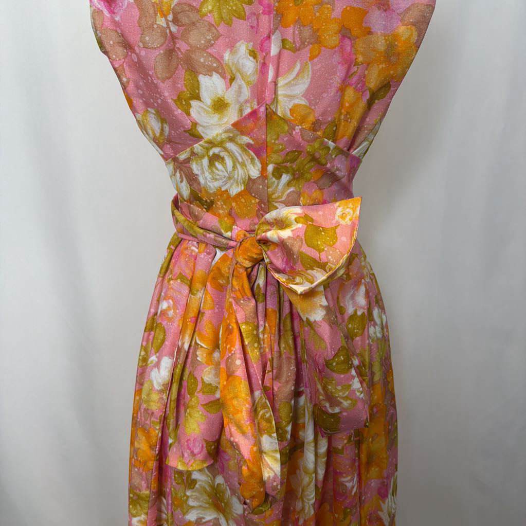Floral dress with pink, orange, and white flowers on a plain background