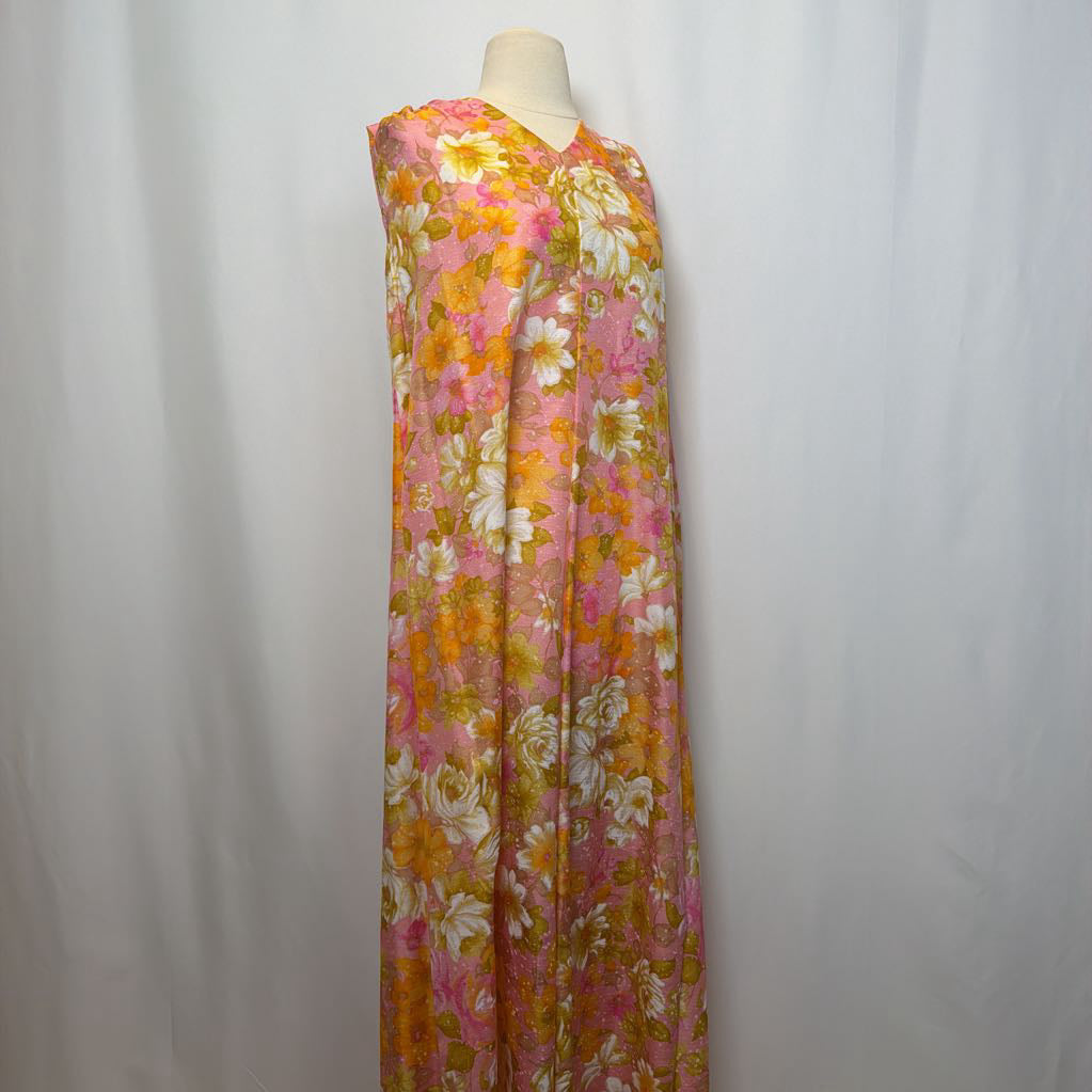 Floral dress on a mannequin against a white background