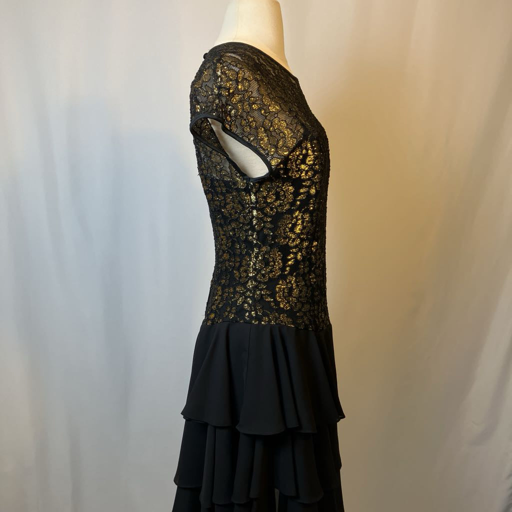 Black lace dress on a mannequin against a neutral background