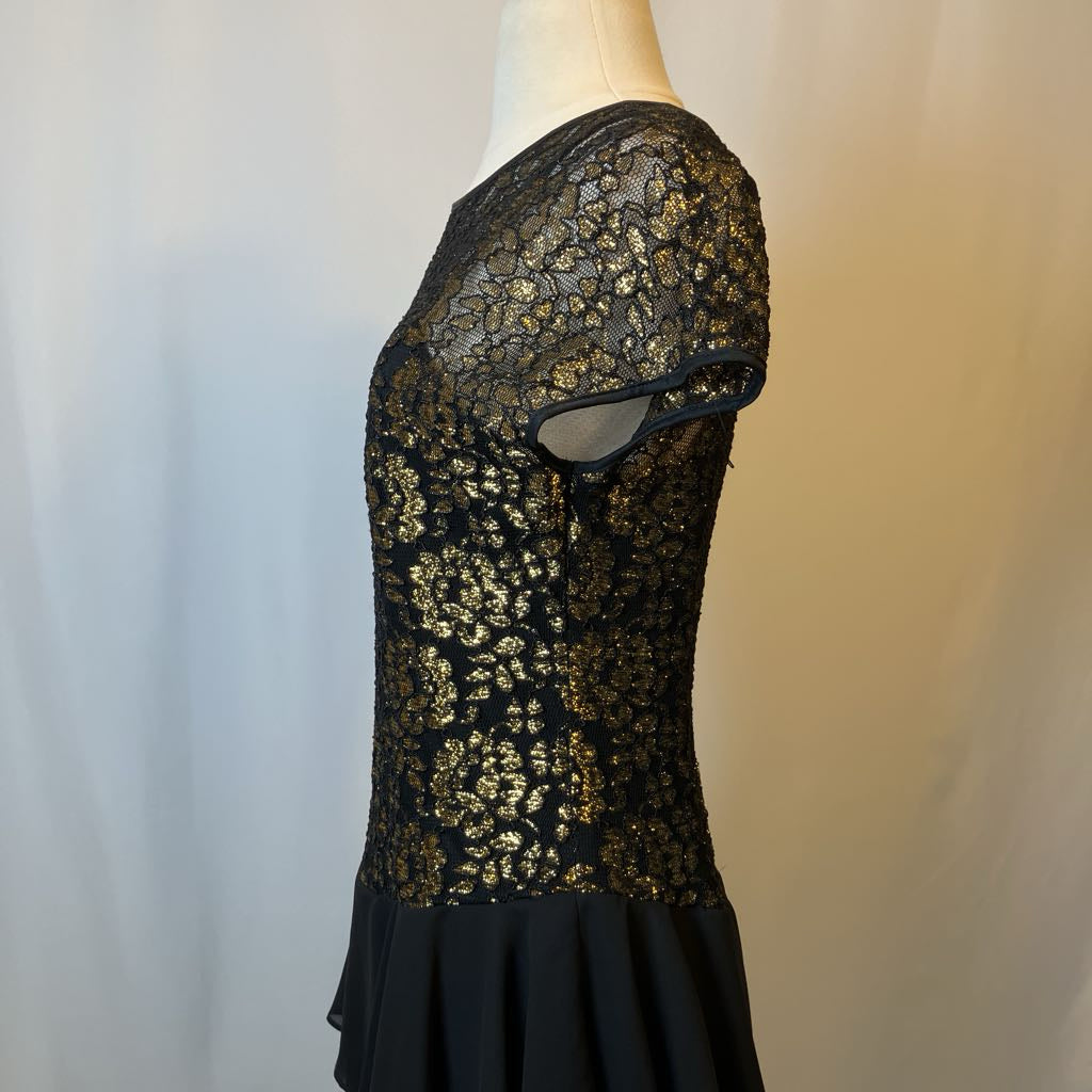 Black lace dress on a mannequin against a neutral background
