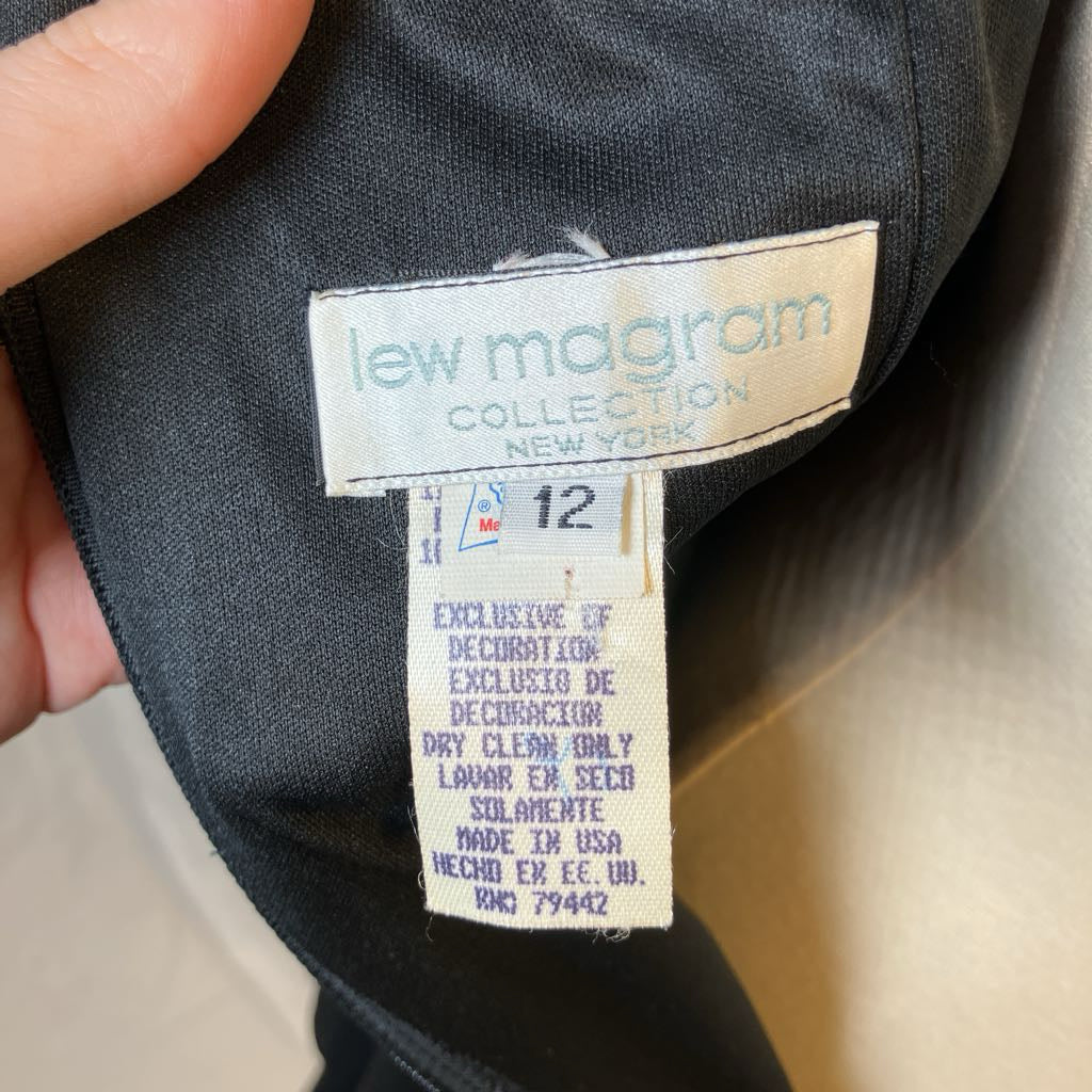Label on a garment with 'lew magram collection' branding and size information.