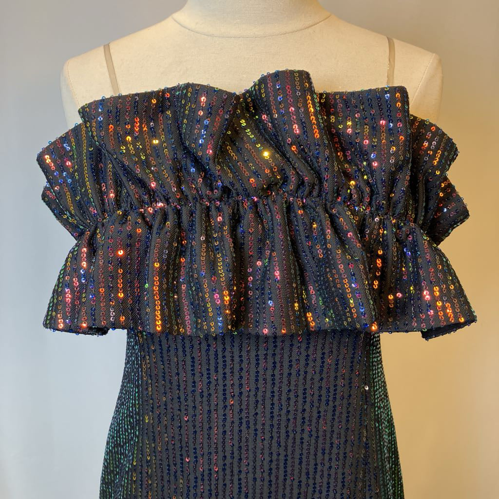 Mannequin wearing a dark blue dress with colorful sequin ruffle on a gradient background