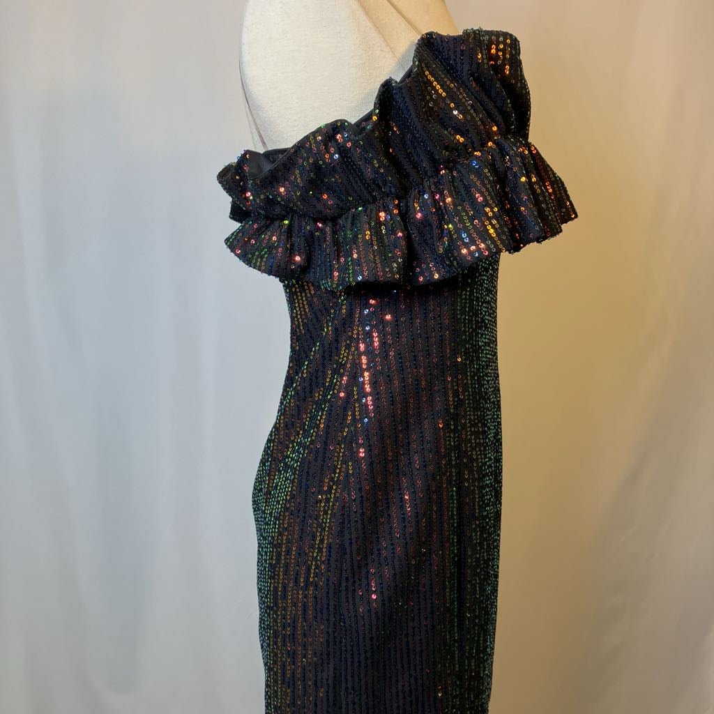 Black sequin dress with ruffled shoulders on a mannequin against a neutral background