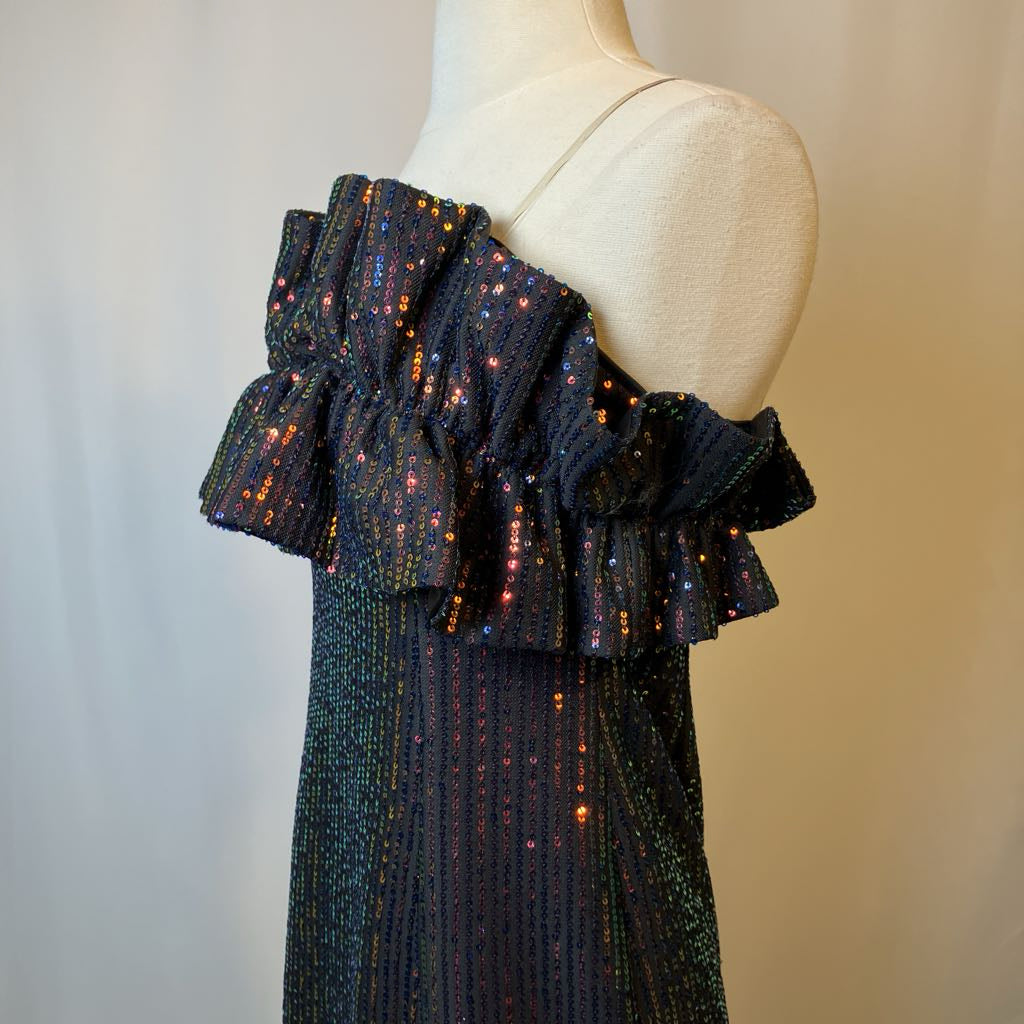 Mannequin wearing a dark blue off-shoulder dress with ruffled details on a plain background
