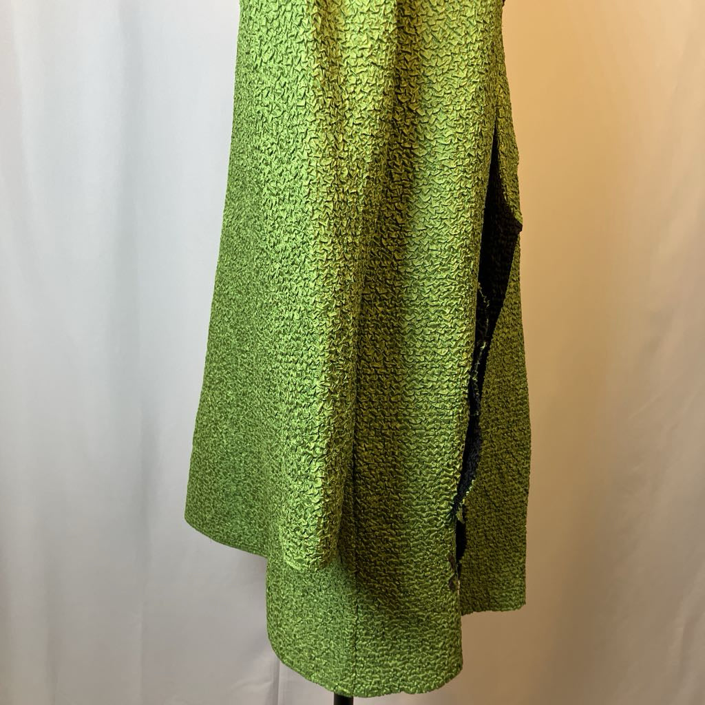 Green textured coat on a mannequin against a plain background