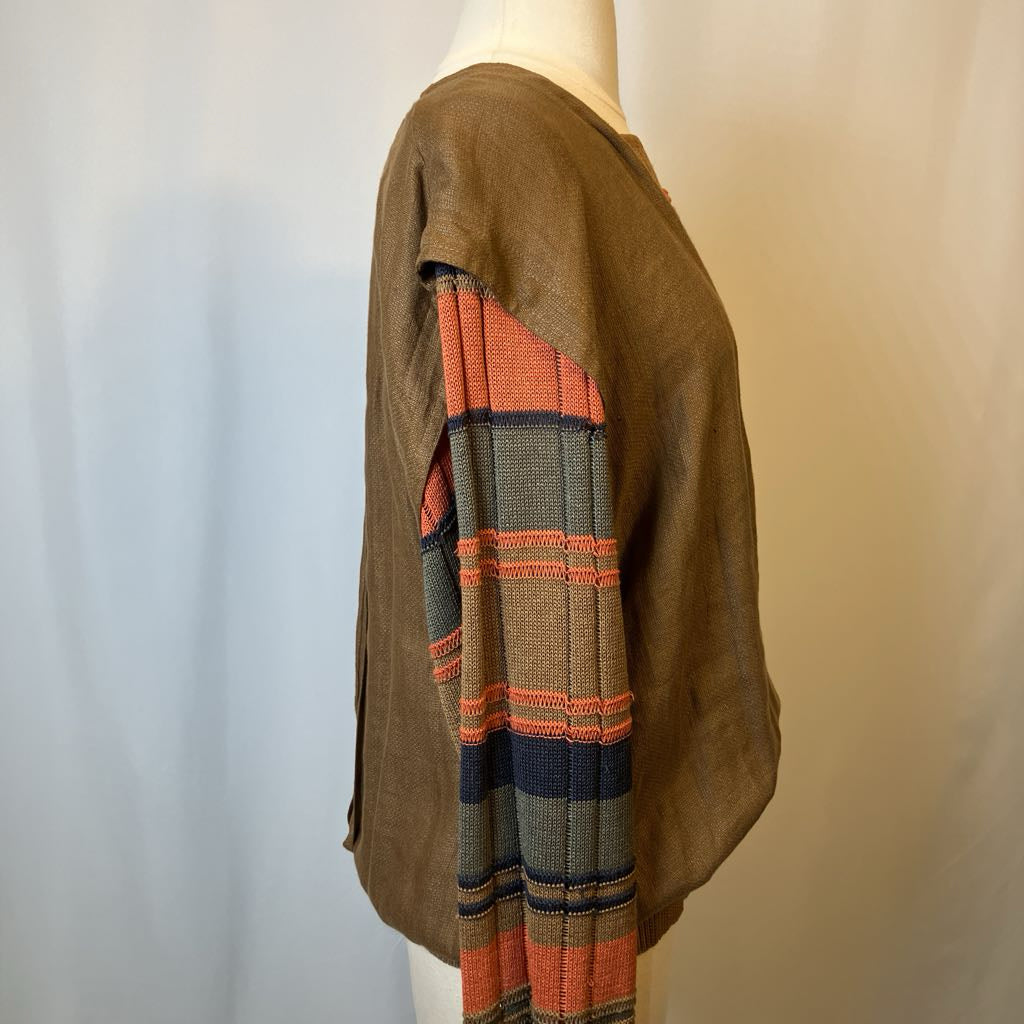 Mannequin wearing a brown jacket with a colorful plaid pattern on a plain background