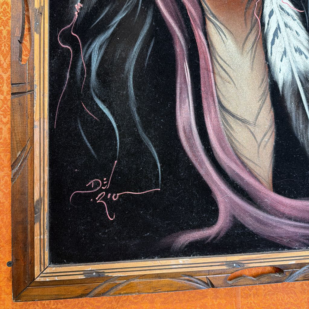Close-up of a painting with a signature on a dark background