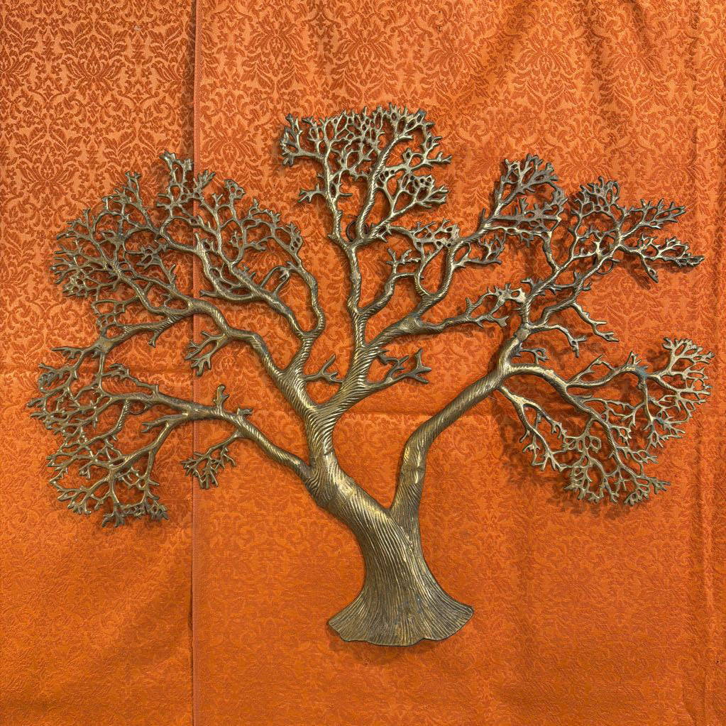 Metal tree sculpture on an orange background