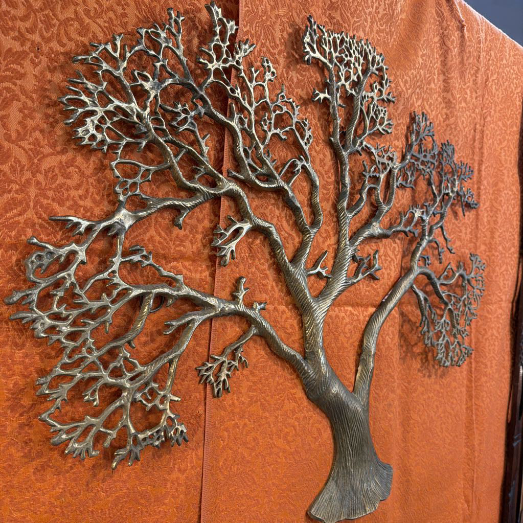 Metal tree sculpture on an orange background