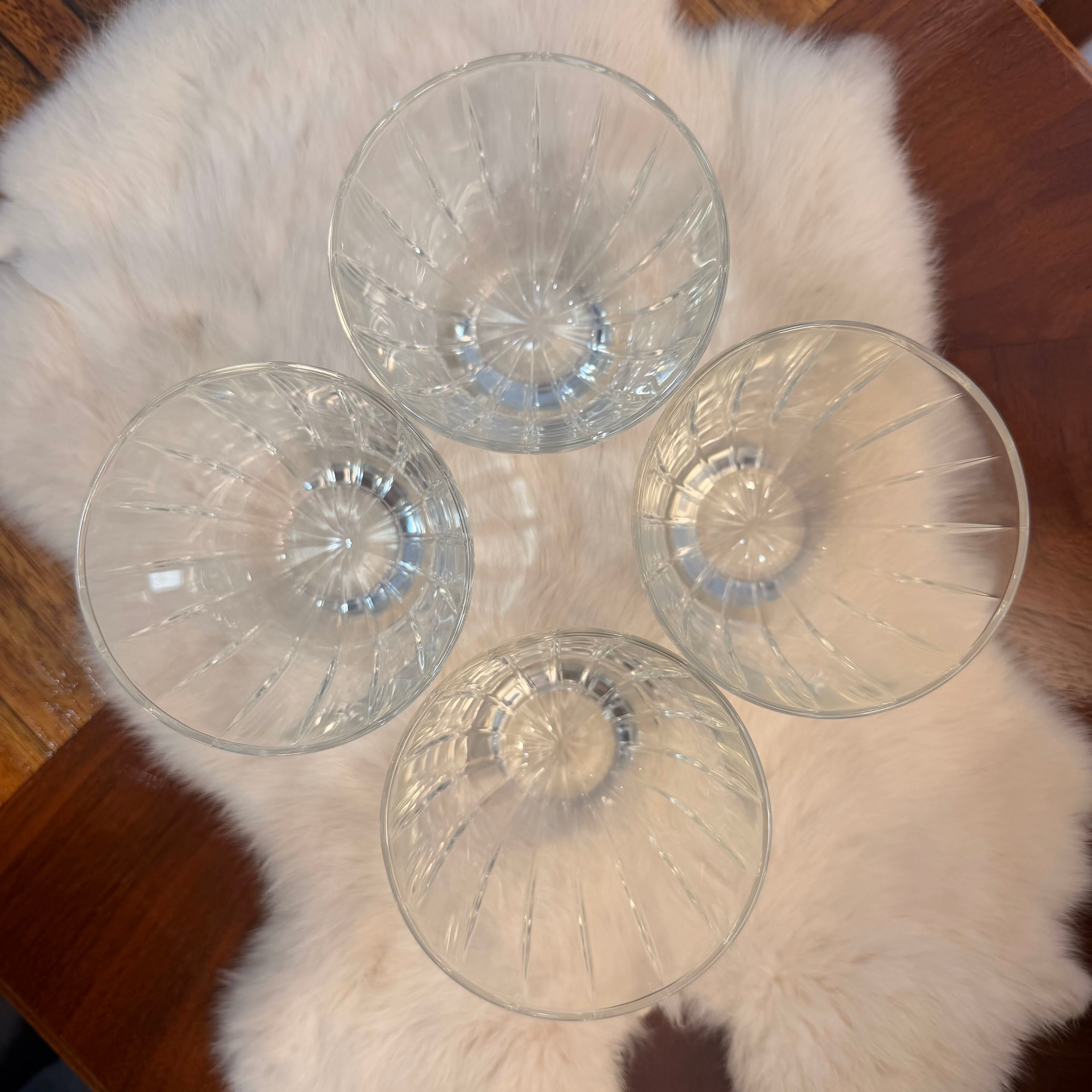 Four clear glass bowls on a fur surface