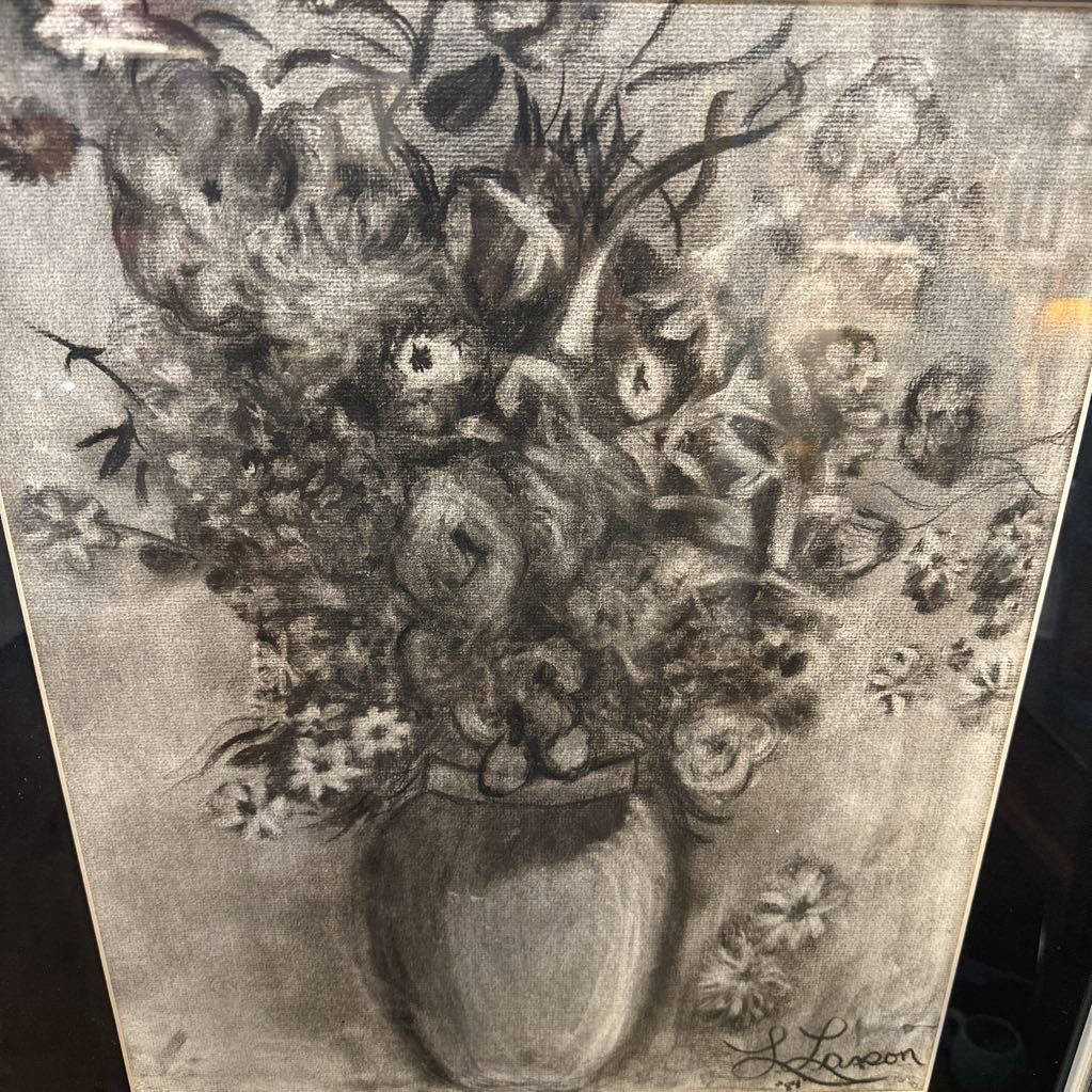 Black and white floral arrangement in a vase on a textured background