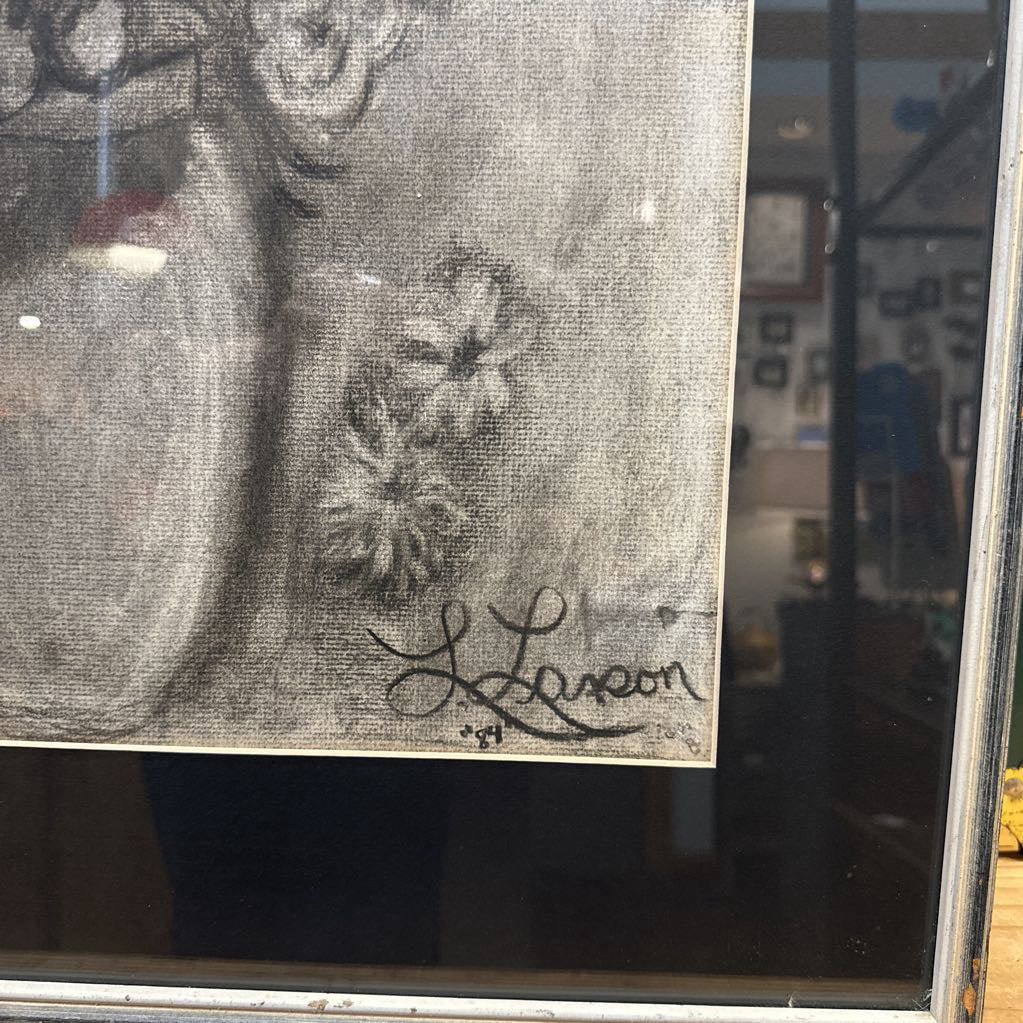 Artistic depiction of a flower with a signature on a glass surface