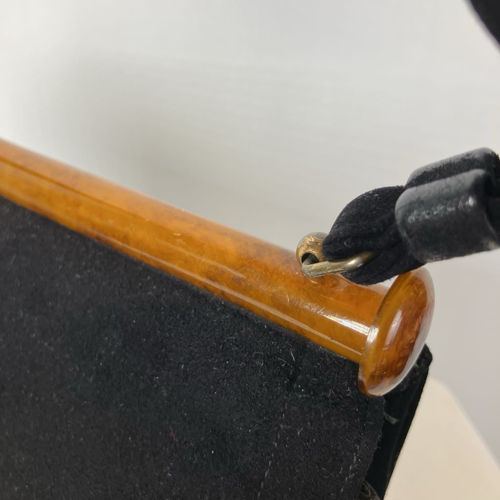 Close-up of a lucite embellishment on a black handle on a white background
