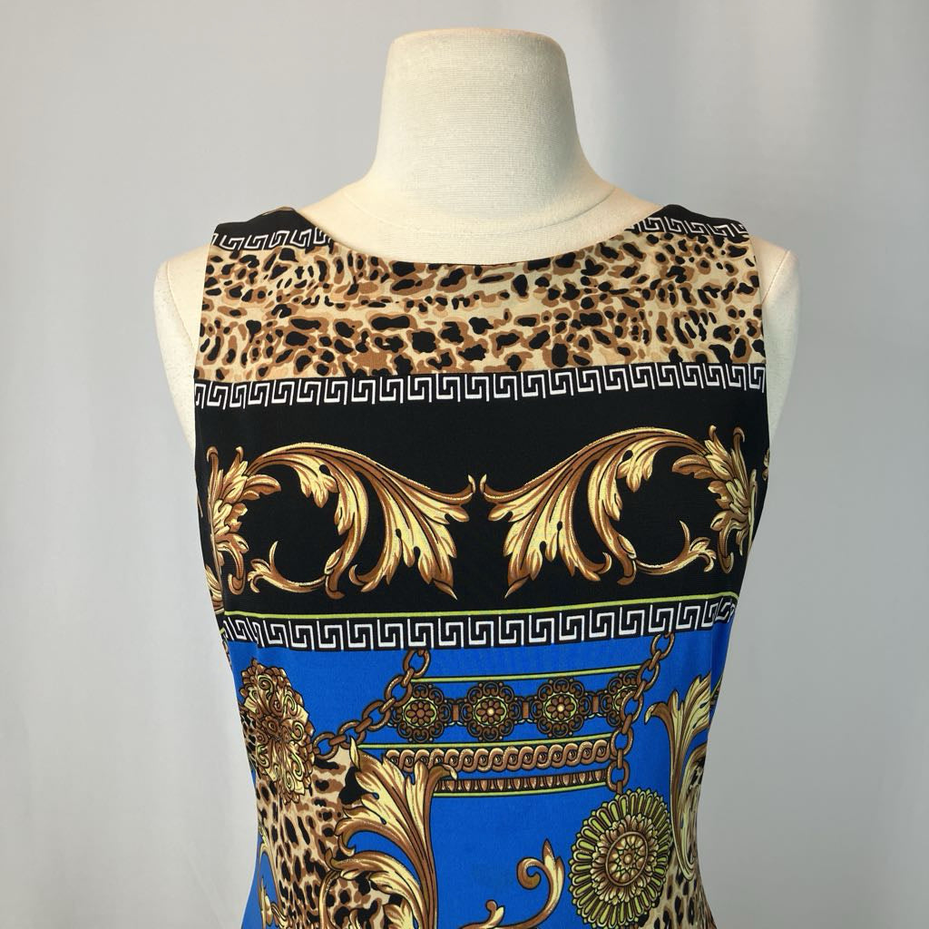 Mannequin wearing a dress with leopard print, gold patterns, and blue background