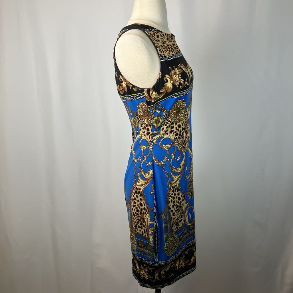 Mannequin wearing a sleeveless dress with leopard print and gold patterns on a plain background