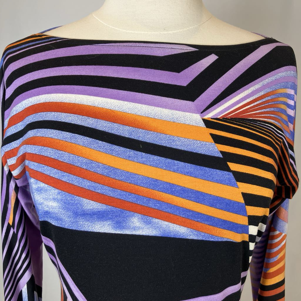 Mannequin wearing a colorful striped sweater with a geometric pattern.