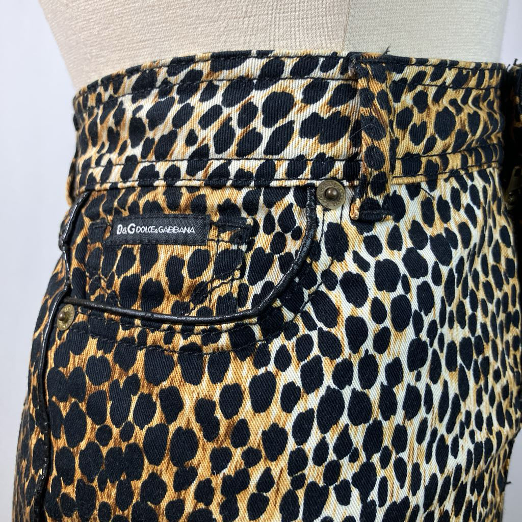 Leopard print pants on a mannequin with 'Dolce & Gabbana' label.
