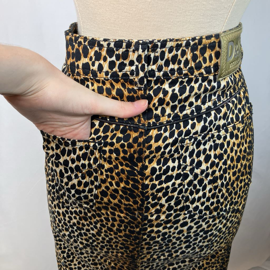 Leopard print pants with a visible brand label on a plain background