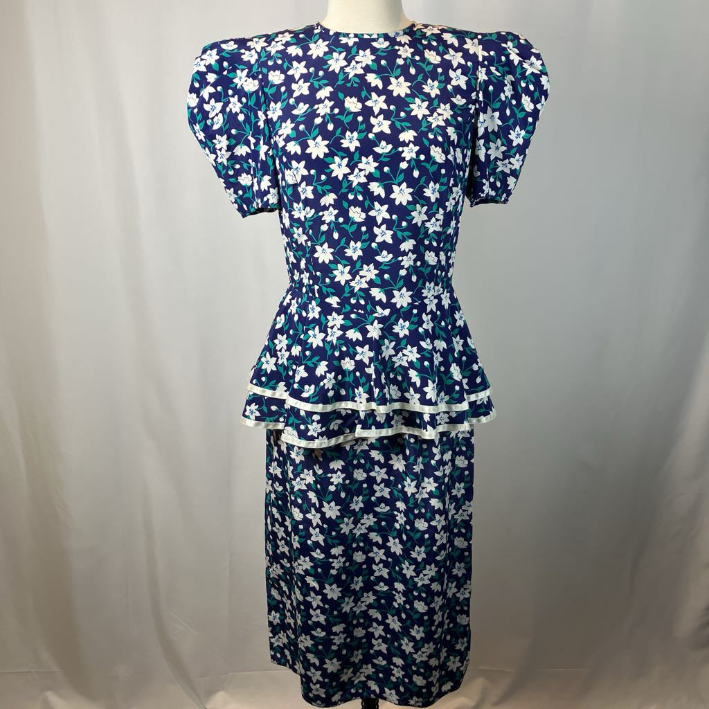 Blue floral dress on a mannequin against a white background