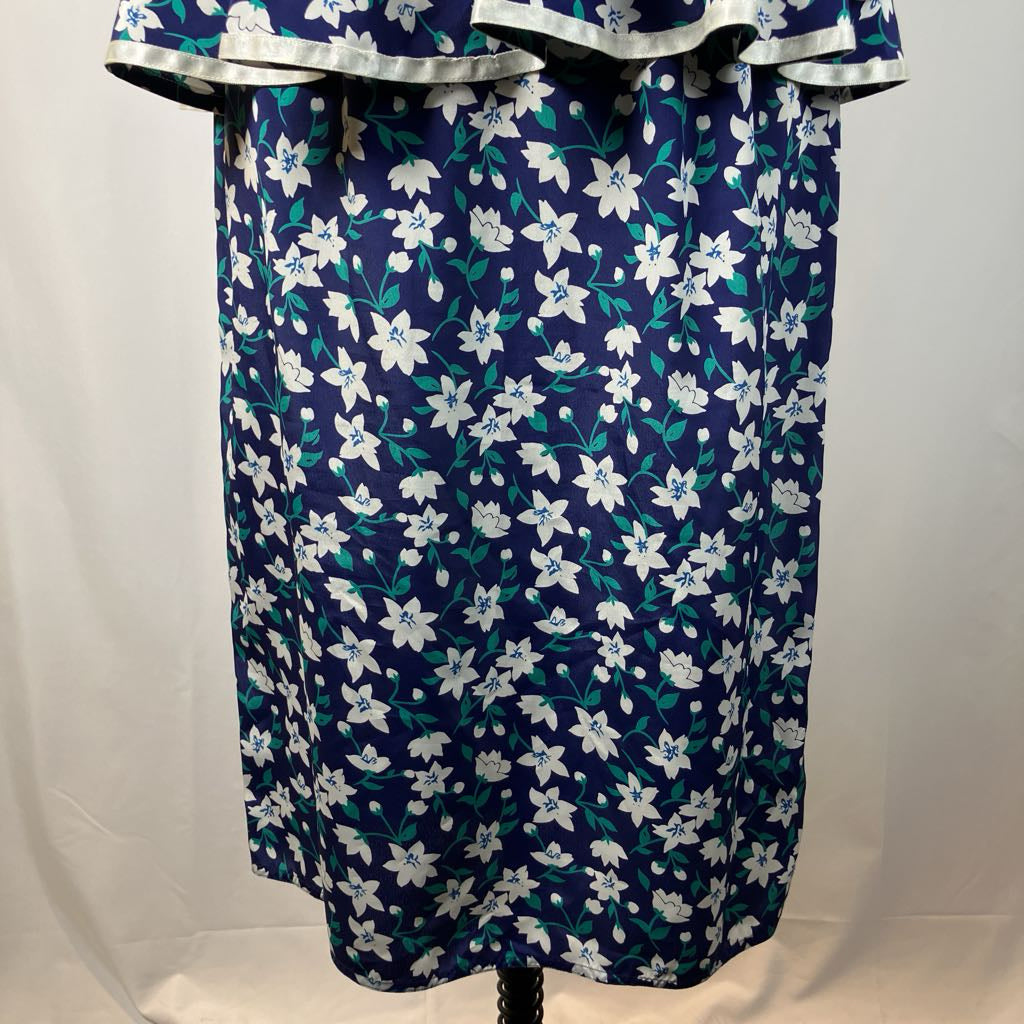 Navy blue dress with white floral pattern on a mannequin against a plain background